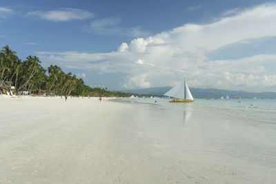 Sailboat on beach against sky