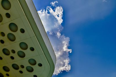 Low angle view of airplane flying against blue sky
