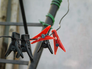 Close-up of clothespins hanging on clothesline