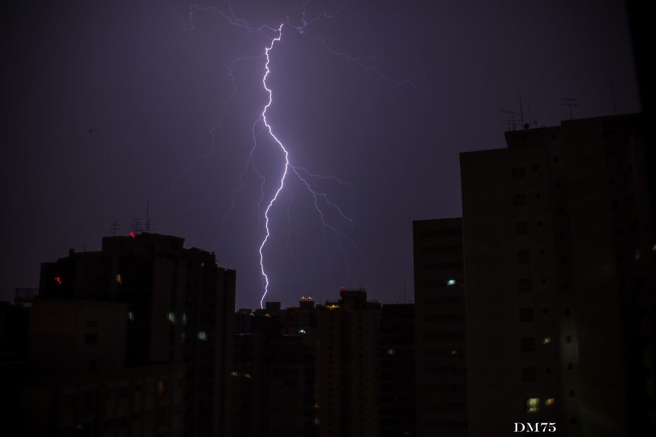 night, building exterior, illuminated, architecture, built structure, sky, city, lightning, low angle view, power in nature, thunderstorm, outdoors, no people, residential building, star - space, building, light - natural phenomenon, dusk, storm, storm cloud