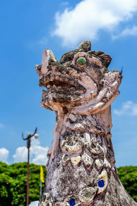 Beautiful lion head sculpture with blue sky background in front of wat phumin, nan province