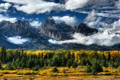 Scenic view of mountains against cloudy sky