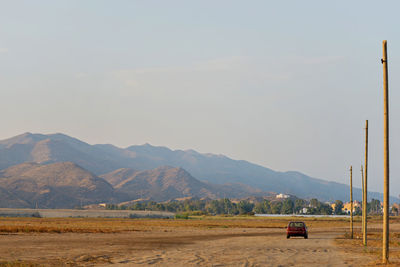 Scenic view of land and mountains against sky