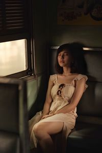 Young woman sitting in train