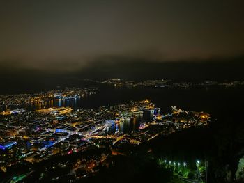 High angle view of city lit up at night