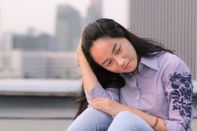 Young woman sitting outdoors
