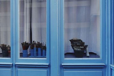 Reflection of window on blue glass door