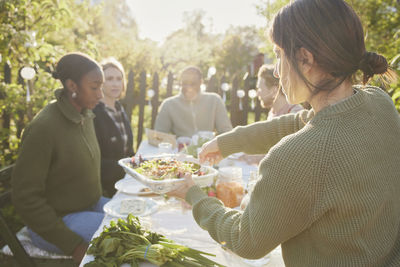 Friends having meal in garden