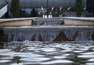 Urban artificial water cascade on restaurant or bar entrance in a city or town.