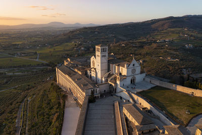 Aerial view of the basilica of san francesco in the city of assisi umbria sunset