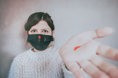 Close-up portrait of woman covering face