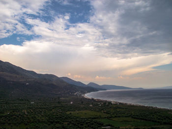 Scenic view of sea and mountains against sky