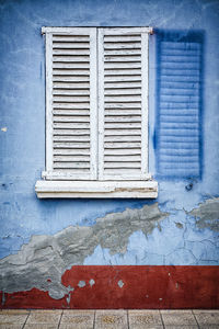 Close-up of window on blue wall