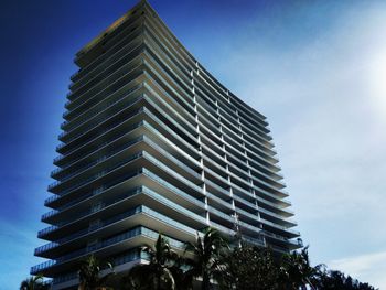 Low angle view of modern building against blue sky