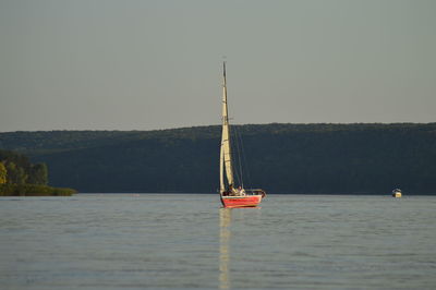 Sailboat on sea against clear sky