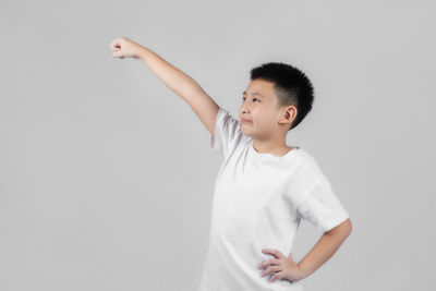 Boy standing against white background