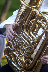 Midsection of man playing wind instrument