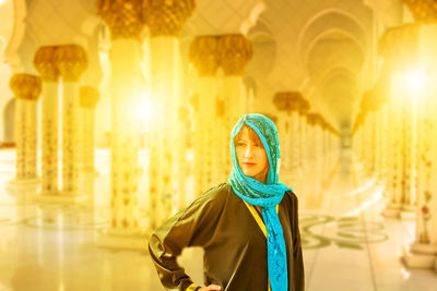 Mature woman wearing headscarf while standing in mosque