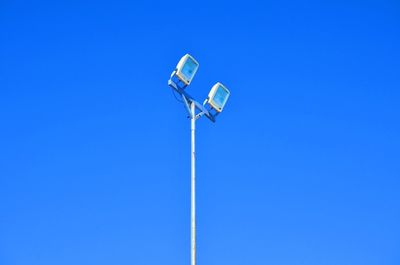 Low angle view of street light against clear blue sky