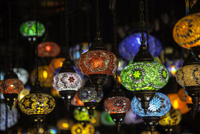 Close-up of illuminated lanterns hanging for sale