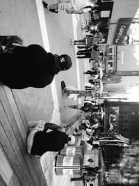 High angle view of people sitting on road