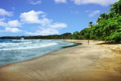 View of beach against cloudy sky