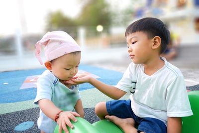 Siblings playing at playground