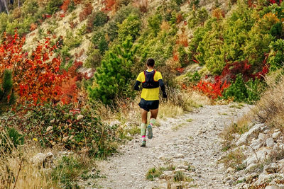 Rear view of woman walking on mountain