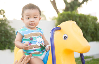 Portrait of cute boy holding toy