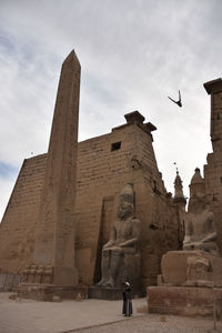 Low angle view of statue against historic building