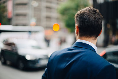 Rear view of man in city street