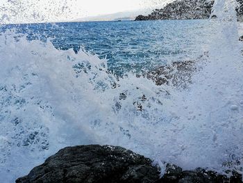 Close-up of sea shore against sky