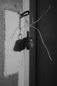 Bell hanging on wall of abandoned house