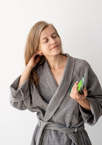 Portrait of a smiling young woman over white background