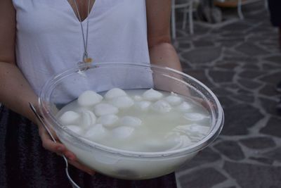 Midsection of woman holding ice cream in bowl