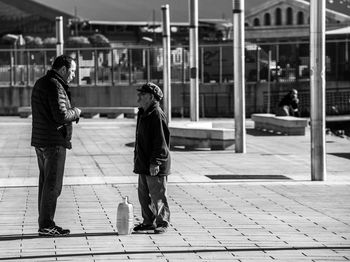 People walking on sidewalk in city