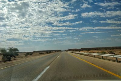 Empty road along countryside landscape