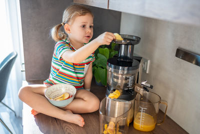 Portrait of cute girl preparing food at home