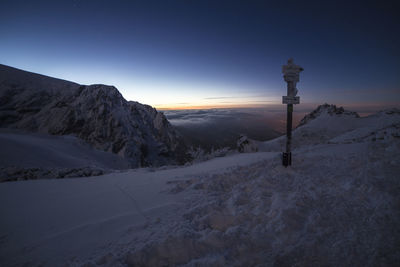 Snow covered mountain against sky during sunset