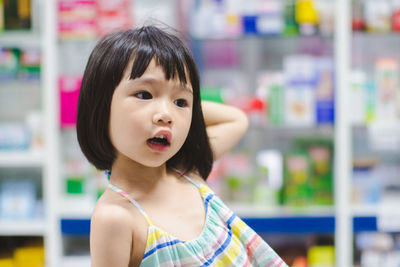 Close-up of cute girl looking away in supermarket 