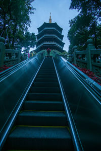 Low angle view of steps amidst buildings against sky