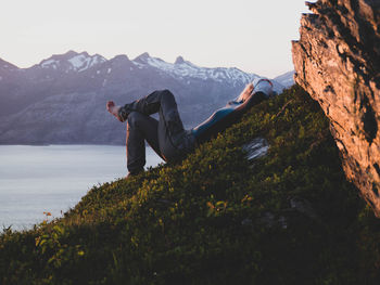 Man on rock against mountains