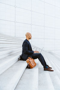 Portrait of young man sitting on snow