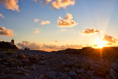 Scenic view of rocks against sky during sunset