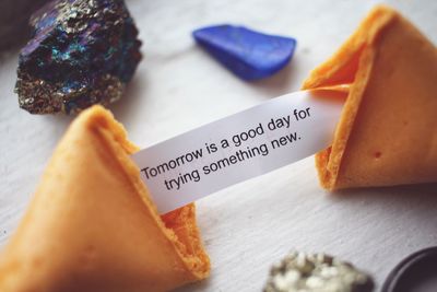 Close-up of fortune cookie with message on table