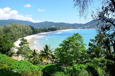 Scenic view of sea and mountains against sky