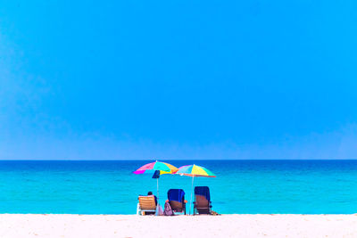 Relaxation on beach against clear blue sky