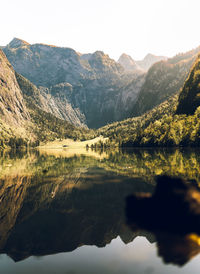 Scenic view of lake and mountains against sky