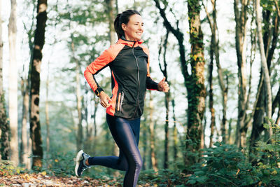 Young woman standing in forest