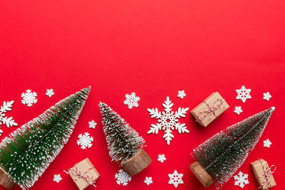 Directly above shot of christmas decorations on red background